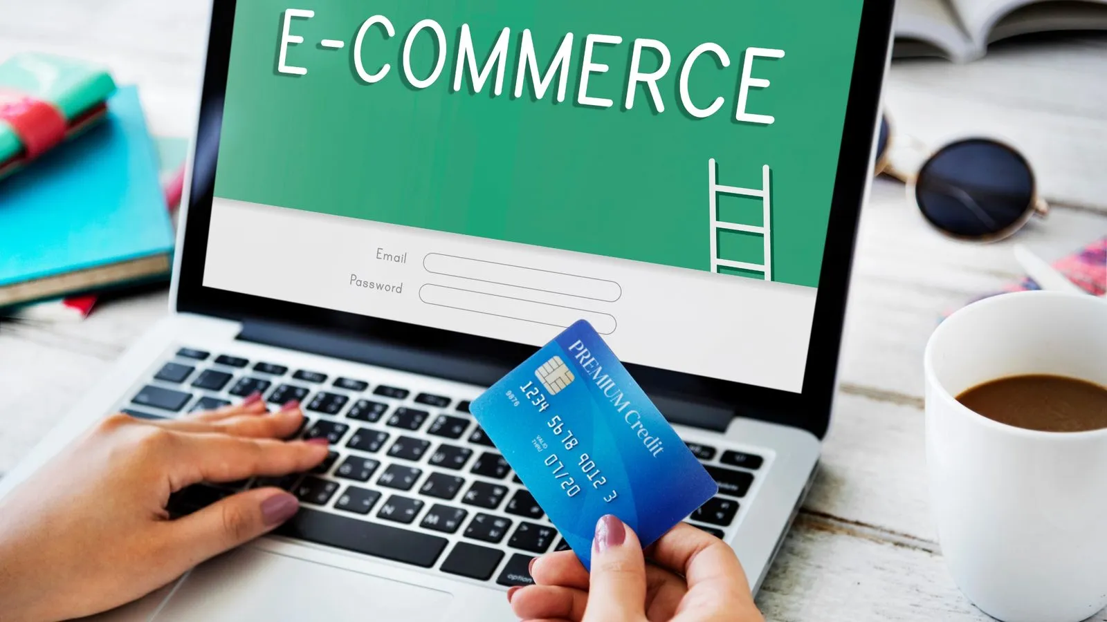 A person shopping online at a laptop, holding a credit card, with “E-commerce” on the screen